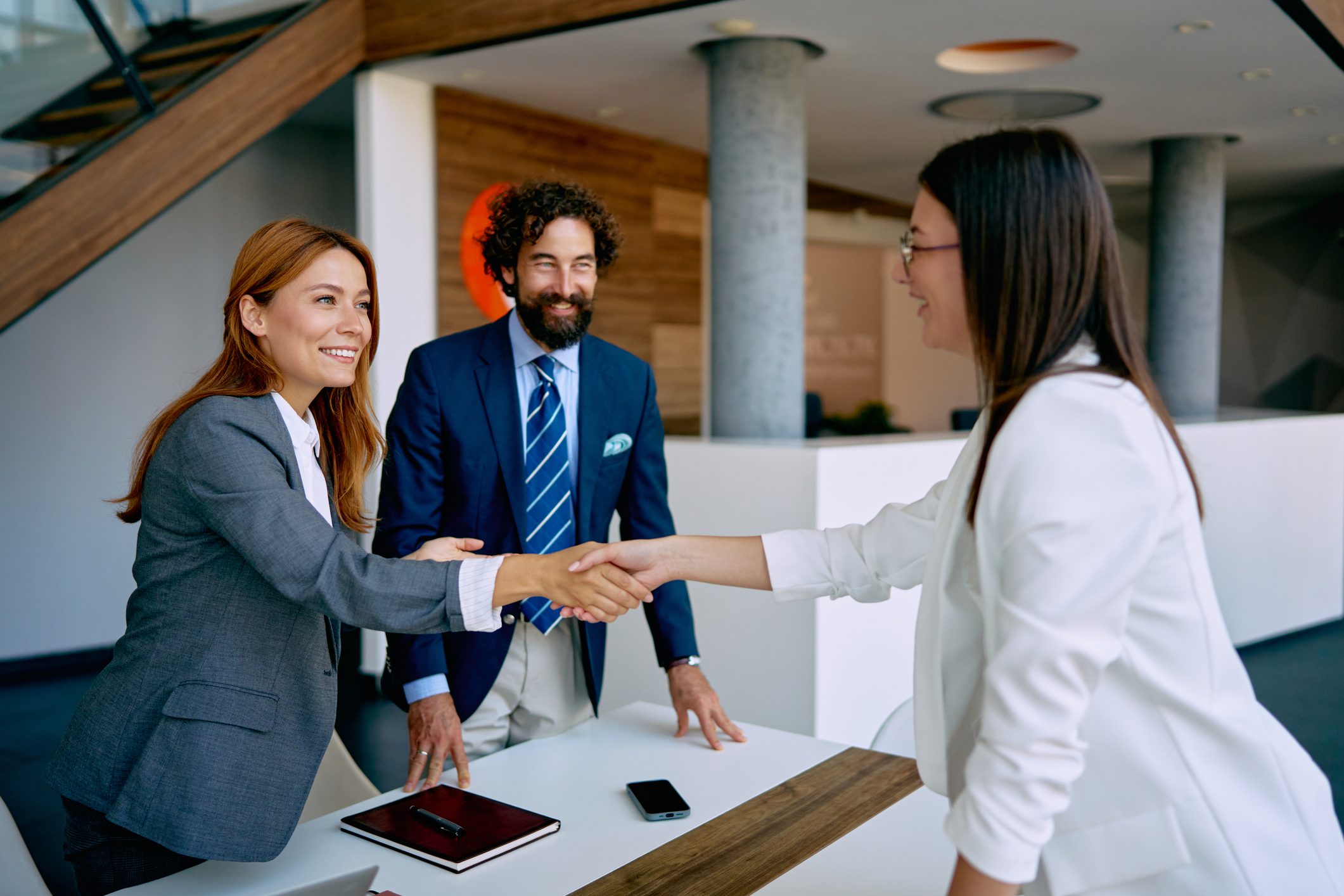 Business meeting handshake in modern office